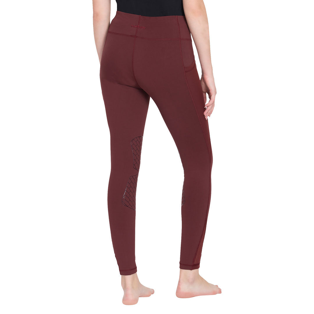 Maroon leggings worn by a person on a white background