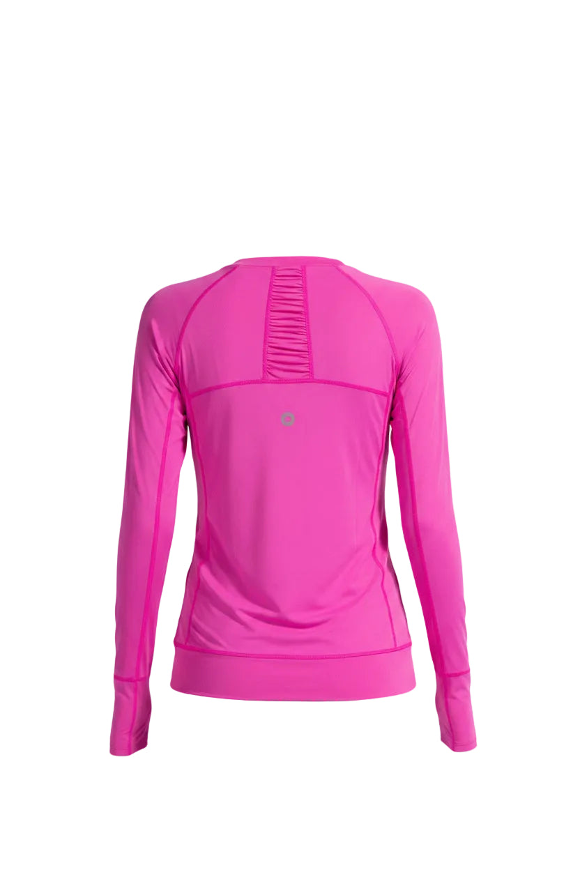 Woman wearing a pink long-sleeve athletic top on a white background