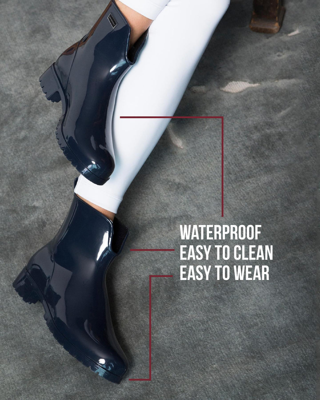 Black rain boots with text highlighting waterproof, easy to clean, and easy to wear features on a gray pavement background.