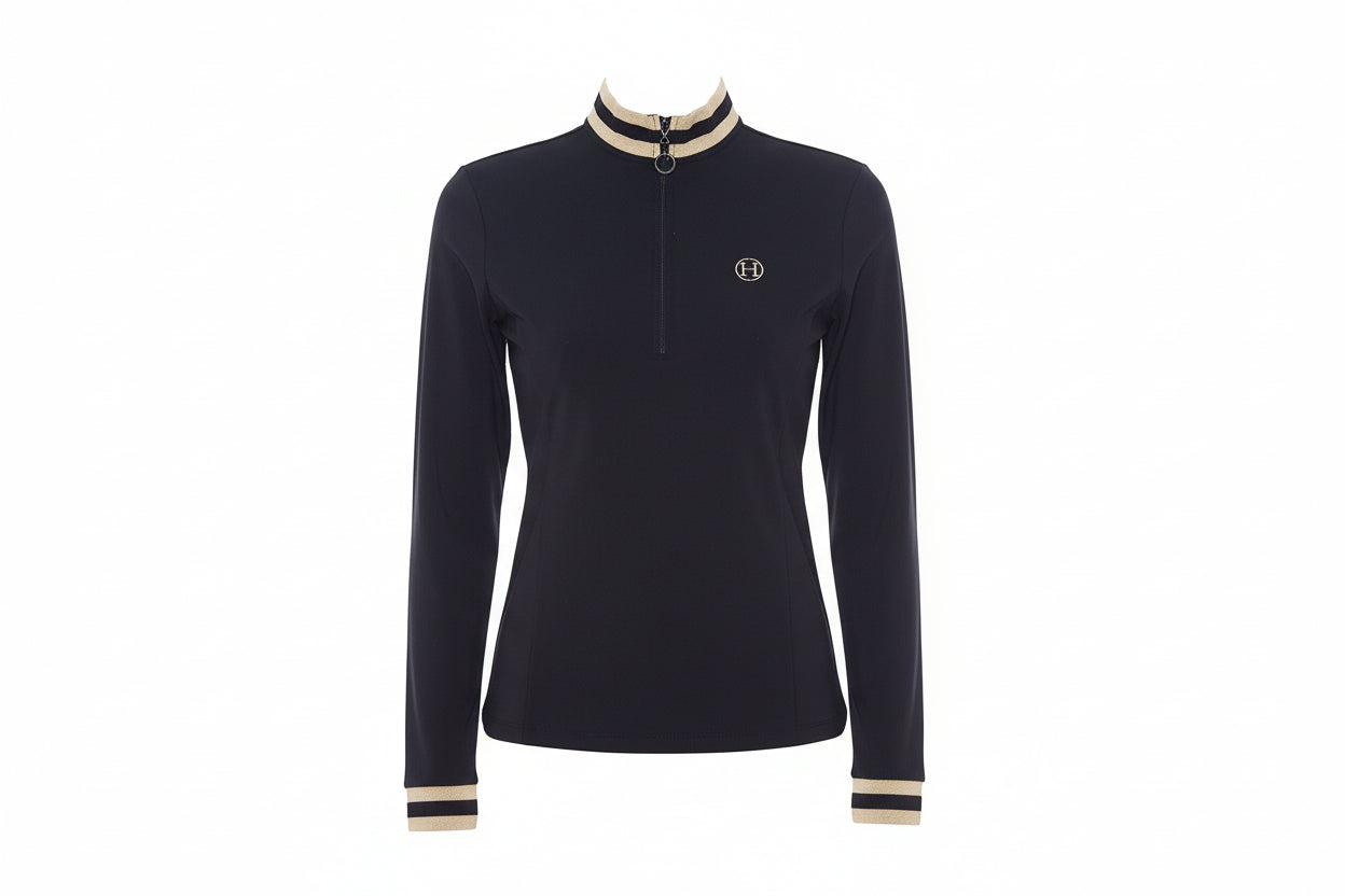 Woman wearing a black long-sleeve top with beige accents on a white background