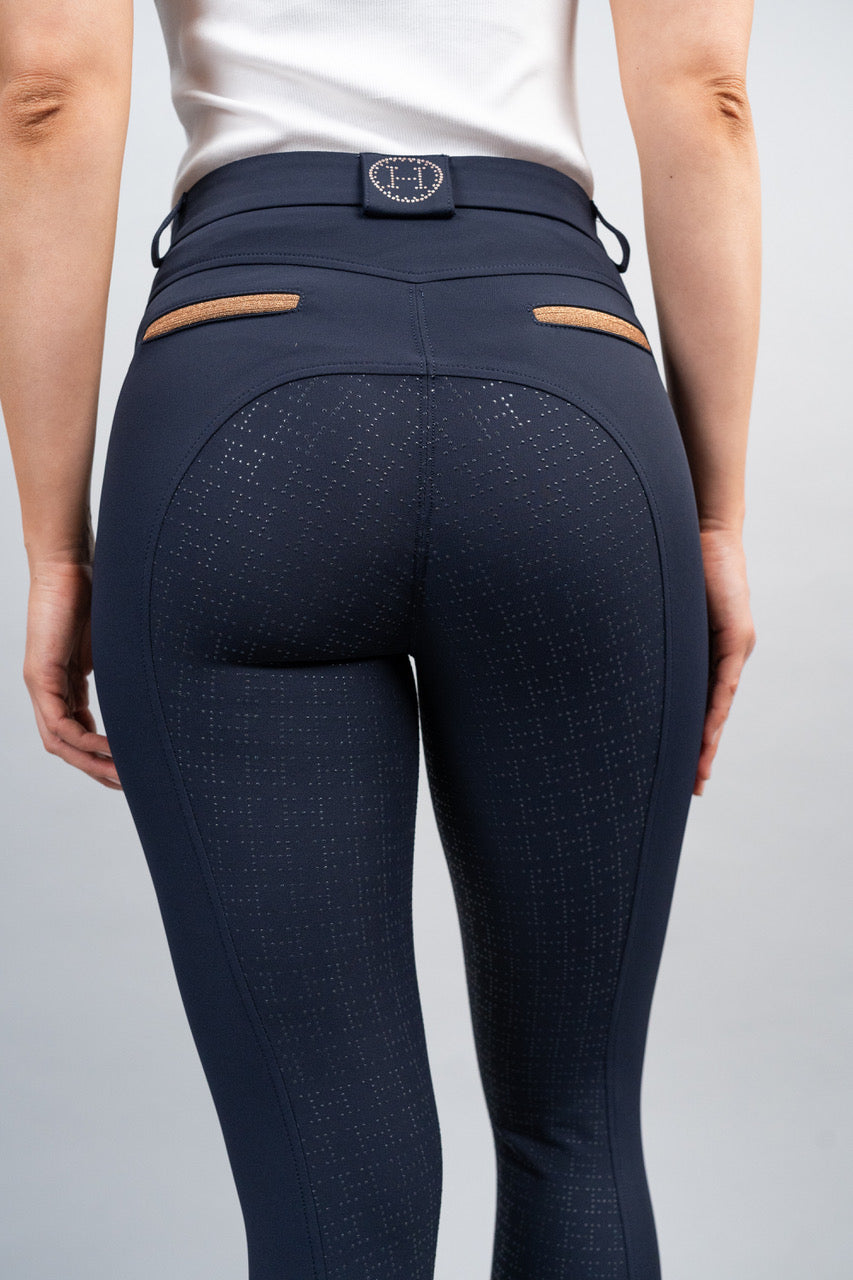 Navy riding pants with a white background