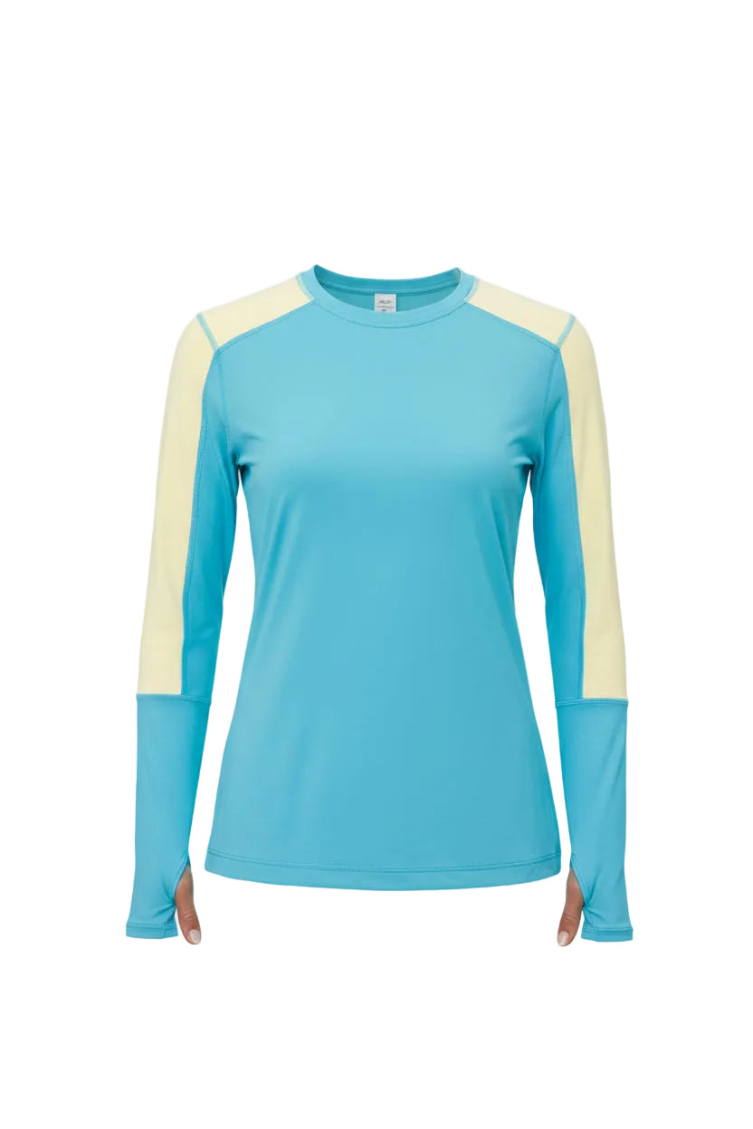 Woman wearing a blue and yellow long-sleeve athletic top on a white background