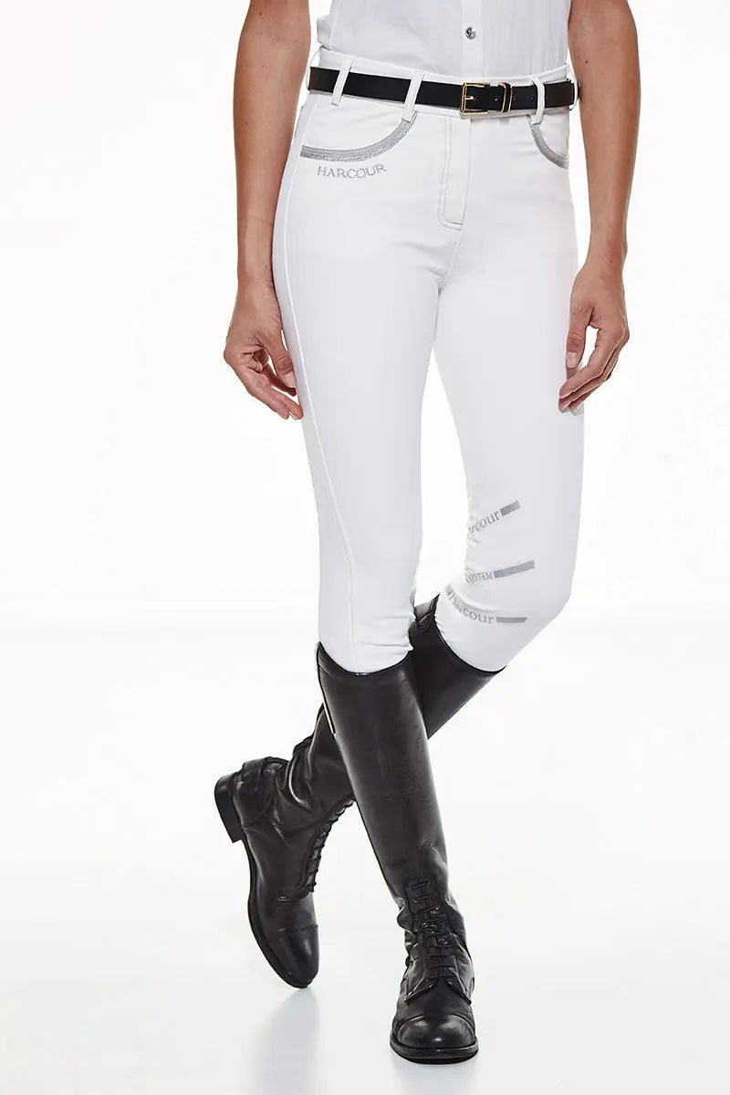 Person wearing white riding pants with a visible brand logo on a white background