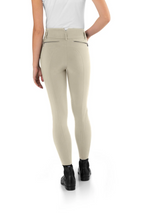 Beige breeches worn by a person on a white background