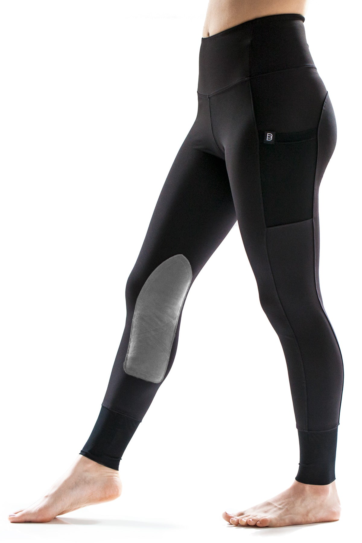 Black equestrian riding leggings with gray patches on a white background