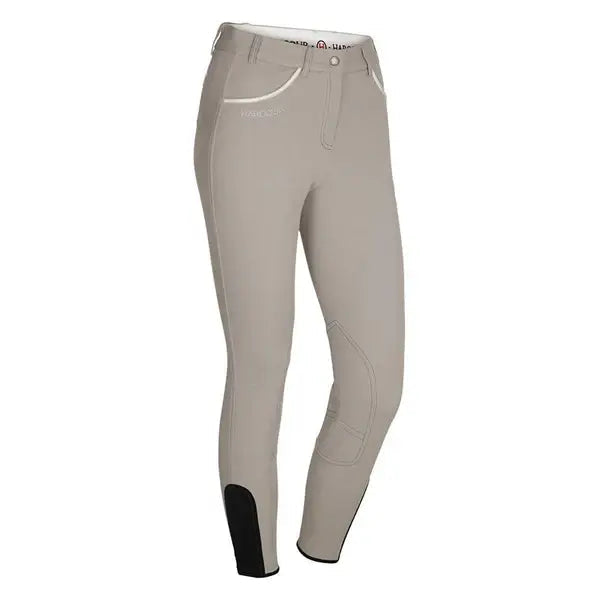 Beige riding pants with black cuffs on a white background