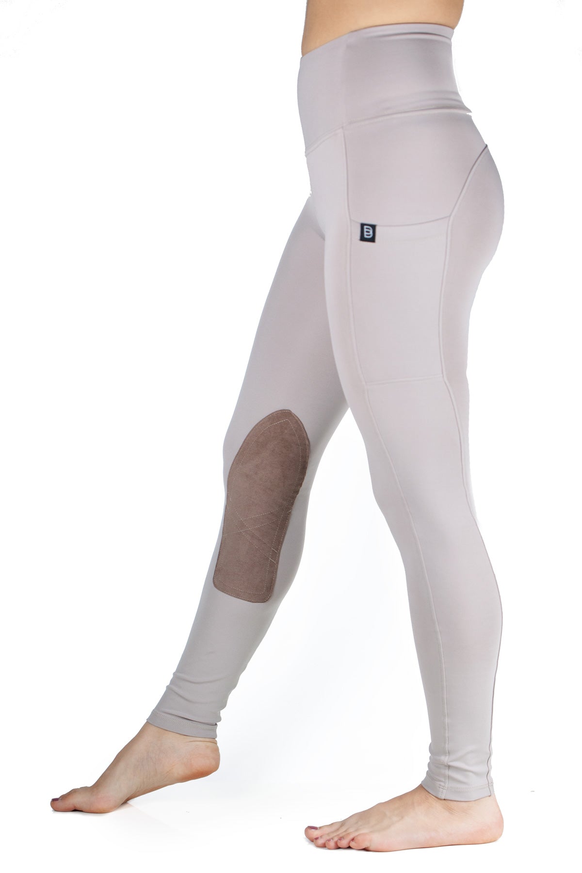 Light gray leggings with a small logo, with phone pocket and light brown knee grip  on a white background