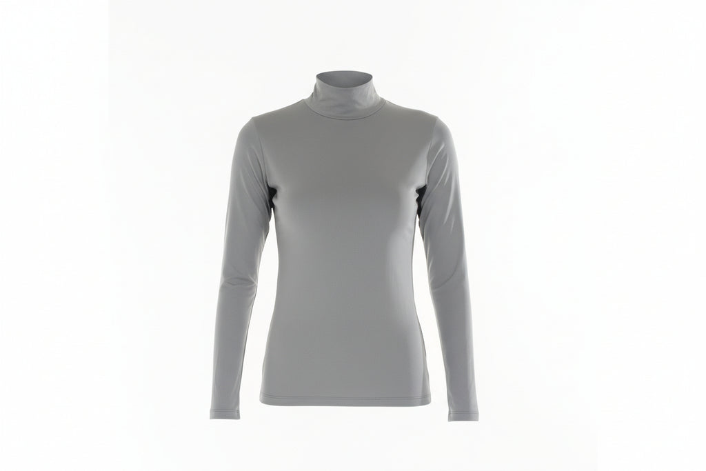 Woman wearing a gray turtleneck and white pants on a white background