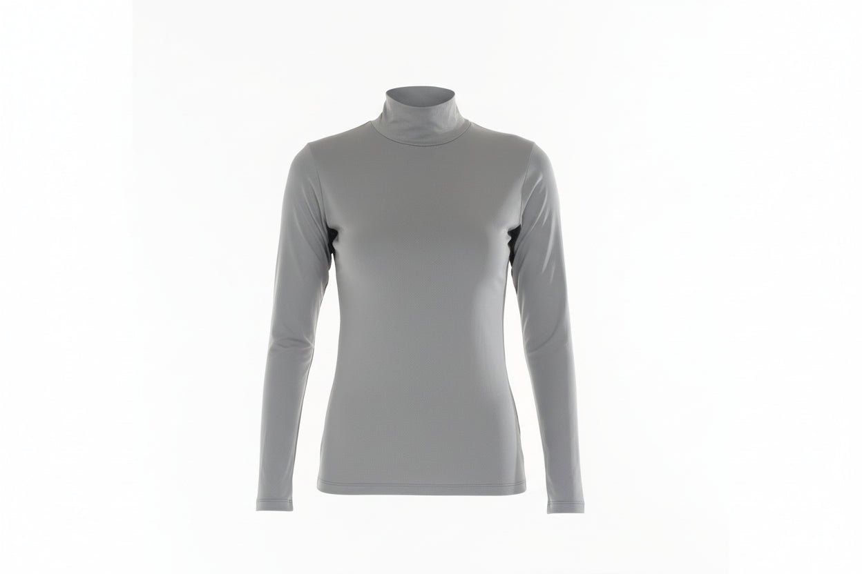 Woman wearing a gray turtleneck and white pants on a white background