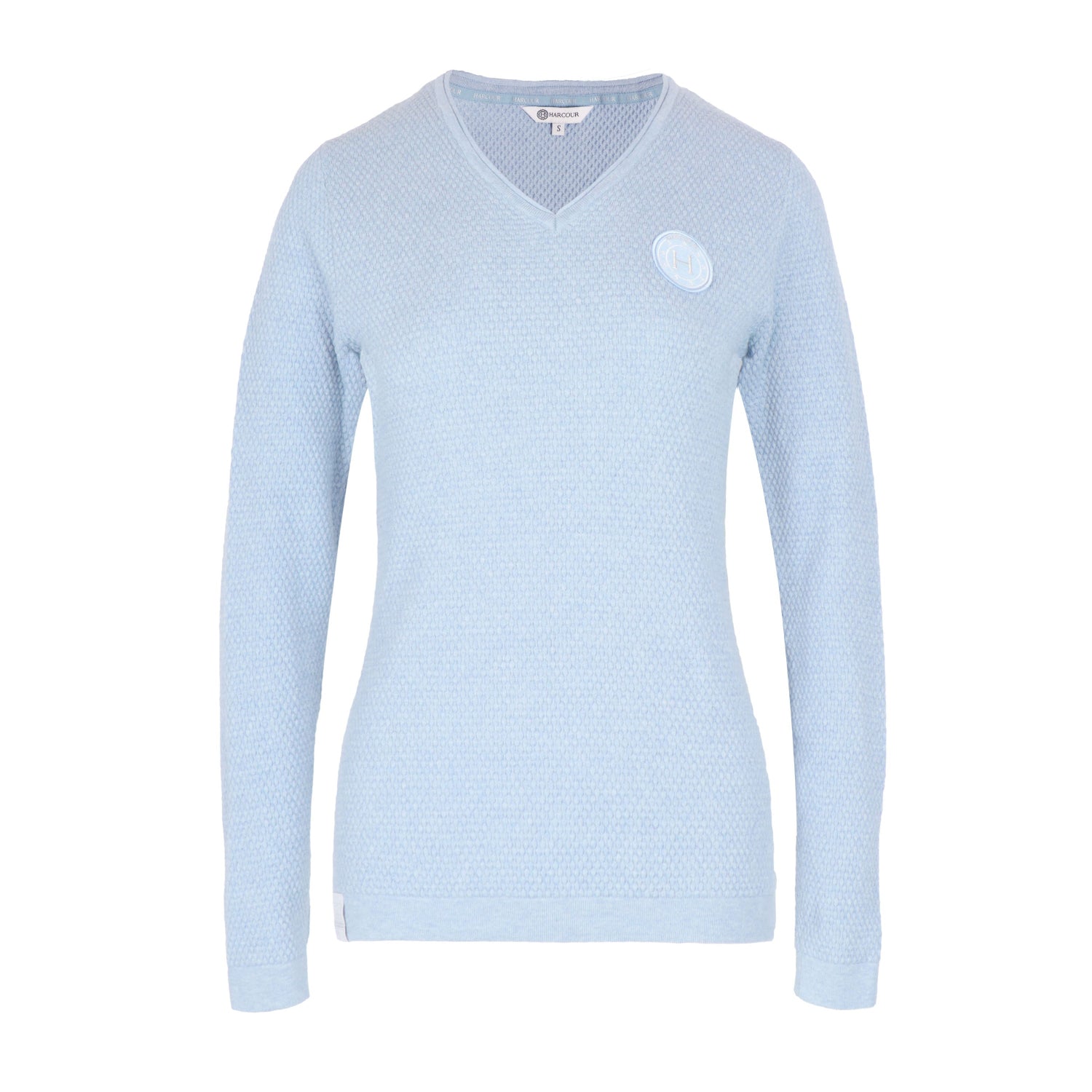 Light blue sweater with a small white logo on a white background
