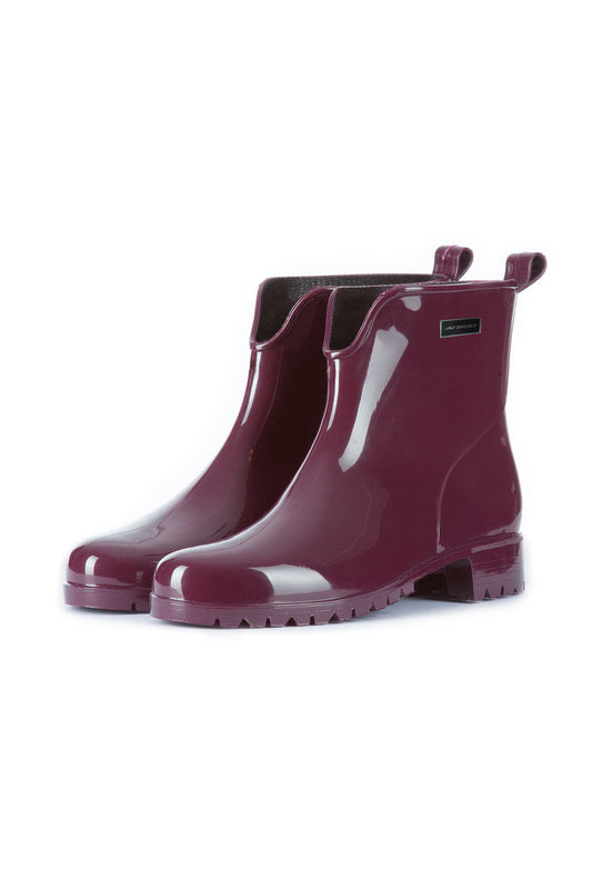 Pair of glossy burgundy rain boots on a white background